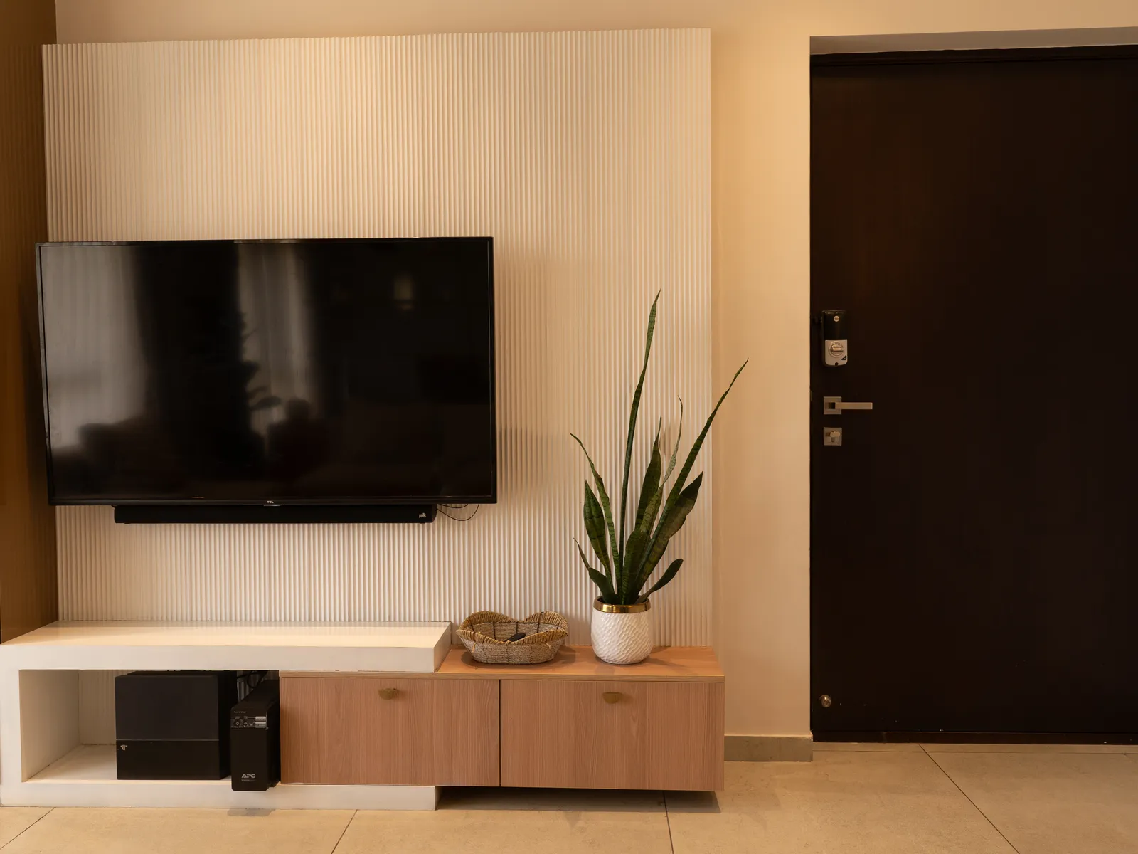 TV unit beside the walnut main door — Amlan's Residence